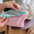 Pink macaron cosmetic bag with blue zipper showing inner fabric and brand label - Pink (Horizontal)