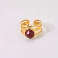 Detailed macro view of gold-plated ring with 10mm round red gemstone inlay and three-band design - Rhodonite