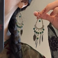 Detail view of vintage bronze teardrop earrings with green beads and leaf metal tassels - 63# Hook-Gold-Green