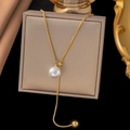 Elegant gold snake chain necklace featuring a white pearl pendant on a luxury jewelry box - Pull Pearl / Gold