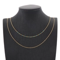 Double-layered golden titanium necklace with small blue beads on a display bust - Sky Blue