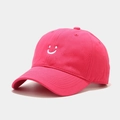 Macro shot of white embroidered smiley face on hot pink cotton twill baseball cap - Adjustable / Rose Red