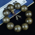 Macro detail of natural golden silk Phoebe wood beads with visible concentric water grains - Premium Accessory Style / 25mm*10 Beads
