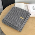Thick grey waffle knit scarf with handmade leather tag on a cozy wooden table - 175cm / Gray