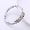 Close-up of silver steel cable bracelet with polished ball ends on white surface - Steel Cable Steel Head