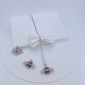 Detailed view of silver bee pendants with cubic zirconia inlay on white display stand - Silver Bee Pendant
