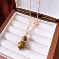 Close-up of tiger eye gourd pendant necklace with zircon detail on vintage wooden box - Pendant Necklace (Necklace-Gold-Coffee-Real Gold Plated)