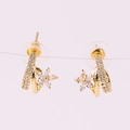Macro view of gold flower earrings with spiral design and sparkling zircon crystals - 18K Gold / White Zirconia