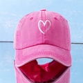 Detailed close-up of a pink washed cotton baseball cap featuring a white heart print pattern - One Size (57-59cm) / Rose Red