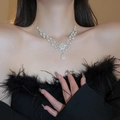 Elegant pearl choker necklace with a vintage heart pendant and sparkling crystals on neck - Metal Filigree Pearl