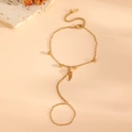 Detail of 18k gold plated finger bracelet featuring dainty beads on a warm stone tray - Gold Steel Bead Ring Bracelet (L412)