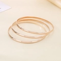 Three-piece stackable round 18K gold plated titanium steel bangles in shiny finish - Inner Diameter 55mm / 3 Rings / Rose Gold