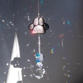 Macro detail of paw-shaped crystal suncatcher with 'I love my dog' heart charm - Heart-Shaped Crystal Style / Silver