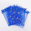 Close-up of blue organza gift bags with gold star and moon patterns and drawstring closure - Star Moon Ribbon/Royal Blue