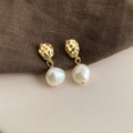 Close-up of baroque pearl earrings with hammered gold metal texture in a vintage style - Style 27