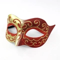 Detail of red and gold glitter painted masquerade mask with ornate spiral patterns - Red
