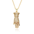 Detailed view of a gold glove pendant with white zircon micro-paving and pink gemstone - Glove Shape