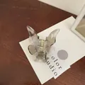 Elegant butterfly hair claw clip featuring translucent ink wash pattern and gold spring - Clear White