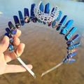Close-up of blue crystals and silver crescent moon pendant on a metal headband - Dark Blue