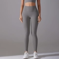 Close-up of gray high-waisted seamless yoga leggings with matte finish and shaping effect - Titanium Gray
