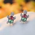 Macro shot of silver turtle stud earrings with red-green gradient stone and zircons - White Gold Plated Red Green Tourmaline Zircon