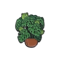 Cute enamel pin badge featuring a green monstera plant with small frogs and a brown pot - Frog Monstera