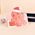 Close-up of pink Christmas card with a cute gingerbread man and Merry Christmas text - Christmas Gingerbread Man