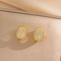Orecchini a cerchio ovali dorati con zirconi bianchi su elegante sfondo beige - Stile Full Pave Oro