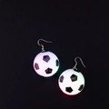Luminous soccer ball earrings with glowing pink and green light on black background - Soccer Ball Earrings