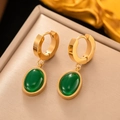 Close-up of elegant gold polished hoop earrings with oval emerald-green stone pendants - EHG3051 Oval Emerald Hoop Earrings Gold