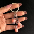 Close-up of hand-held resin bubble tea keychain with mini pink drink cup pendants - Dusty Pink