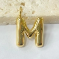 Detailed macro view of a gold chubby bubble letter M pendant with hand relief design - Letter-M / Steel
