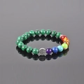 Seven chakra tree of life bracelet with green striped beads on reflective surface - Green Malachite Tree of Life 7 Chakra Bead Bracelet