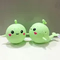 Vue détaillée du jouet baleine vert clair avec des expressions faciales mignonnes - Baleine Verte