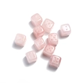 Detailed view of ten pink natural quartz stone dice with smooth finish on white background - Rose Quartz