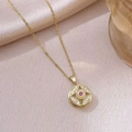Rotating flower pendant necklace in gold with a central red ruby and crystal accents - X3168 Flower Rotating