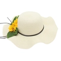 Detailed view of wide-brimmed straw hat with wavy edges and yellow sunflower accents - Cream