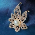 Rose gold leaf brooch with clear rhinestones and large pearl on navy blue fabric - Hollow Pearl Corsage