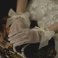 Detail shot of white mesh bridal gloves featuring a large decorative tulle bow - Mesh Bow White