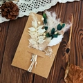 Preserved flower greeting card with white leaves and eucalyptus on brown kraft paper - Messenger