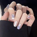 Close-up of lilac mermaid style press-on nails with shell carving and pearl details - By1420 A Bright Future / Glue Type
