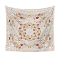 Detail of bohemian mandala tapestry featuring sun, moon and floral patterns on beige fabric - Sun Moon Astrology