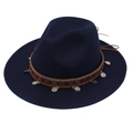 Detailed macro view of the ethnic silver charms and woven band on this navy wool felt hat - Navy Blue