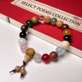 Close-up of colorful multi-material bodhi seed bracelet with red ancient book background - Budget Style (Crystal)