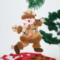 Detailed plush snowman ornament with red checkered hat hanging on a green Christmas tree - Snowman