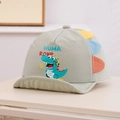 Close-up of cute cartoon dinosaur print and colorful fabric tabs on kids sun hat - 48cm (6-20 Months) / Bean Green