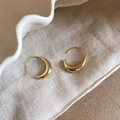 Polished crescent-shaped golden hoop earrings on a textured white fabric background - A2279 Gold Polished Crescent