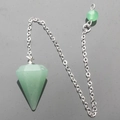 Macro shot of a green hexagonal crystal pendulum with a silver chain and matching bead - Green Aventurine