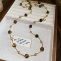 Vintage tiger eye stone and pearl beaded necklace displayed in a jewelry tray - Brown