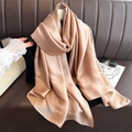 Champagne silk-like scarf draped on a sofa with soft lighting and luxury texture - Dark Khaki